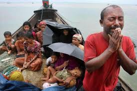 A Rohingya man pleads with authorities as families try to shelter on a typical boat used by migrants to escape the Bangladesh Myanmar border area Source Bangkok Post