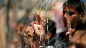 Palestinian boys watch a scene simulating clashes between Palestinian stone-throwers and Israeli soldiers in Gaza Cit