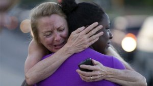 Survivors comfort each other following the Aurora mass shooting. Photo Getty Images.