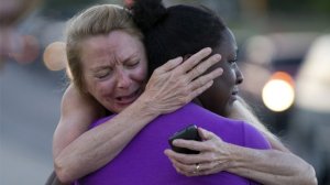 Survivors comfort each other following the Aurora mass shooting. Photo Getty Images.