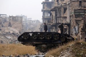 Forces loyal to Syria's President Bashar al-Assad stand atop a damaged tank near Umayyad mosque, in the government-controlled area of Aleppo, during a media tour, Syria December 13, 2016. REUTERS/Omar Sanadiki TPX IMAGES OF THE DAY